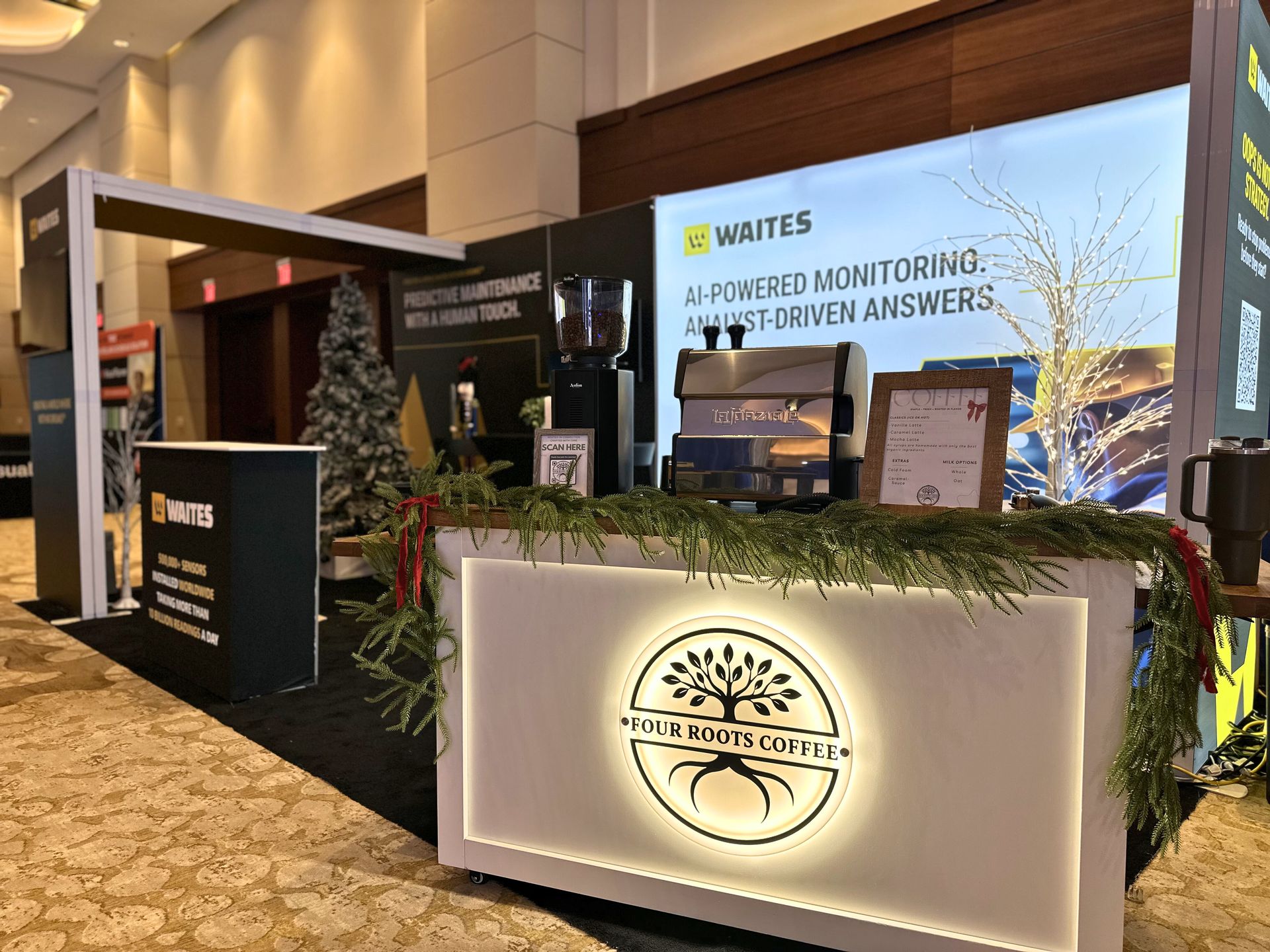 Four Roots Coffee cart positioned beside a corporate convention exhibit