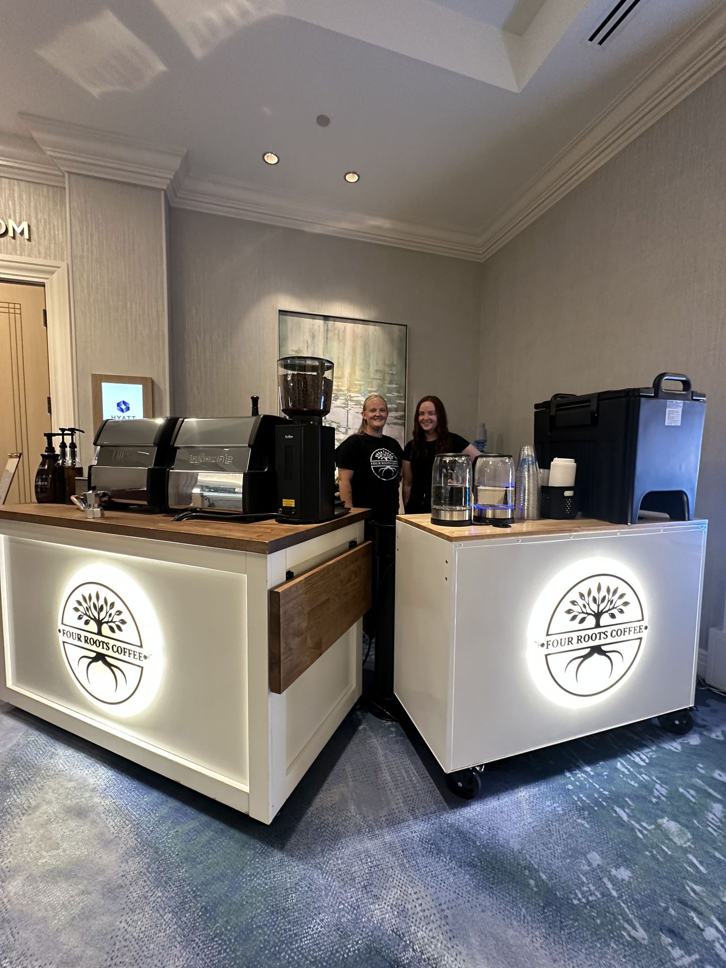 Four Roots Coffee team with two mobile coffee carts at a corporate hotel event