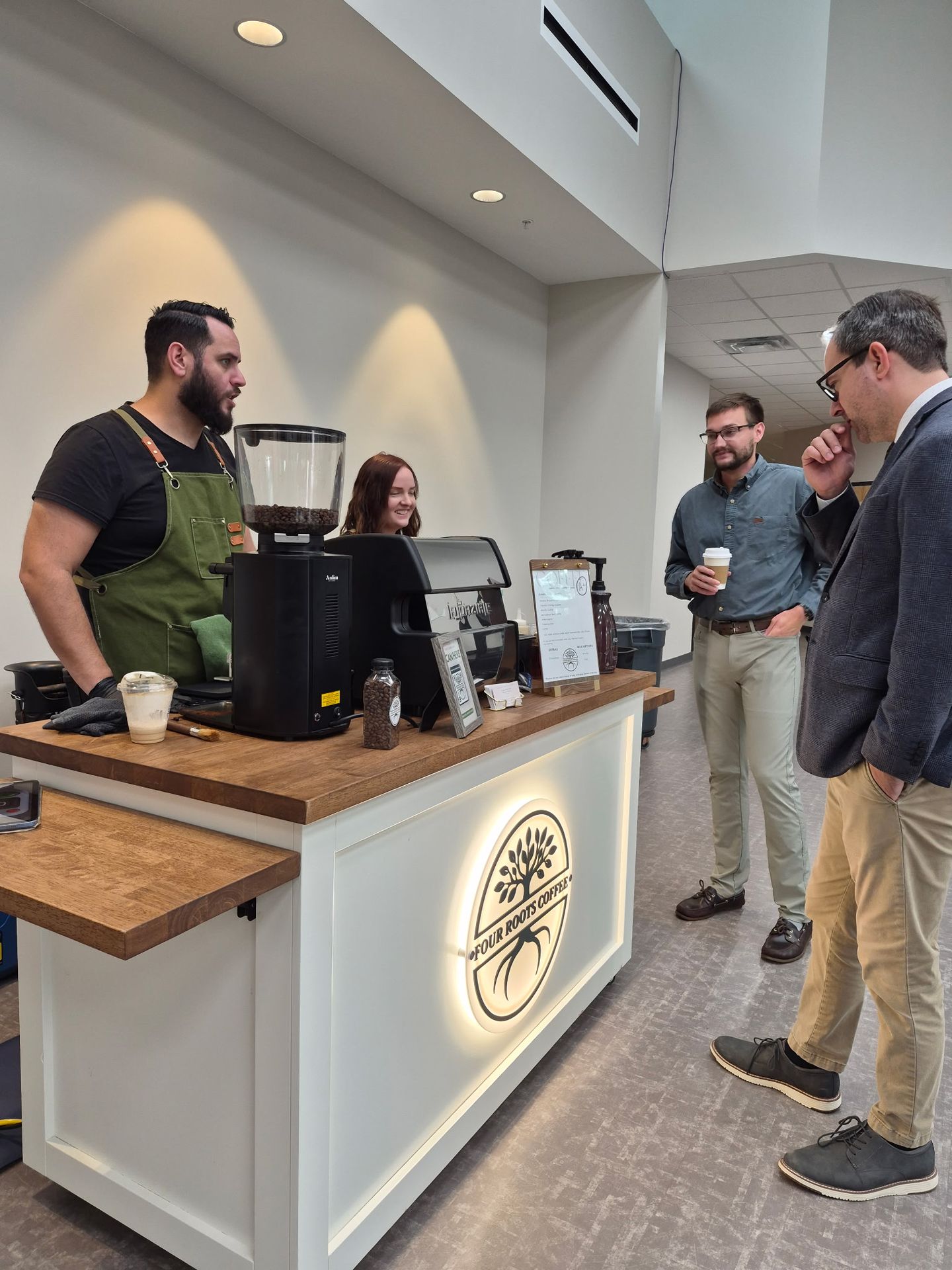 Four Roots Coffee baristas serving guests at a corporate event