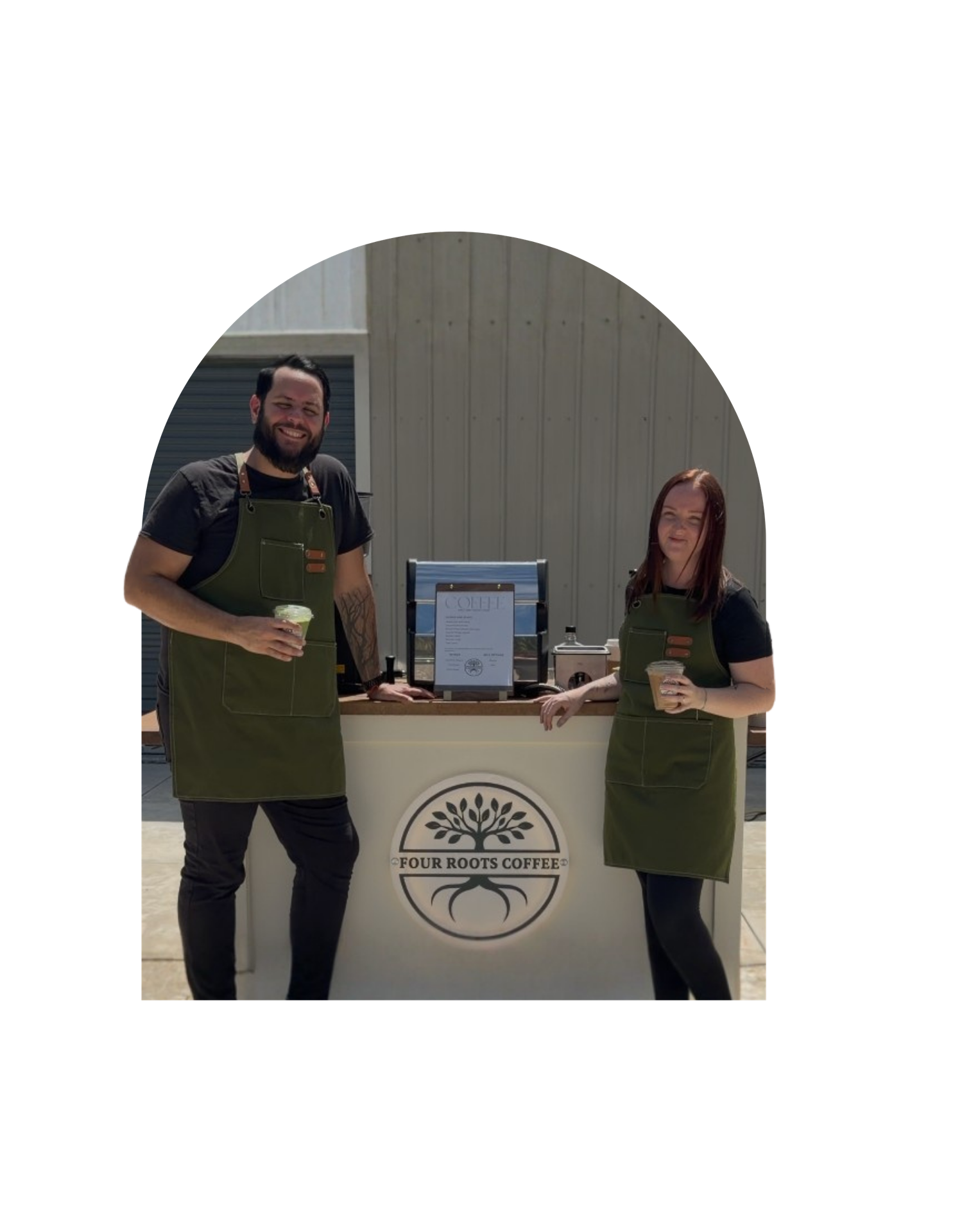 Hector and Megan, founders of Four Roots Coffee, standing with their mobile coffee cart